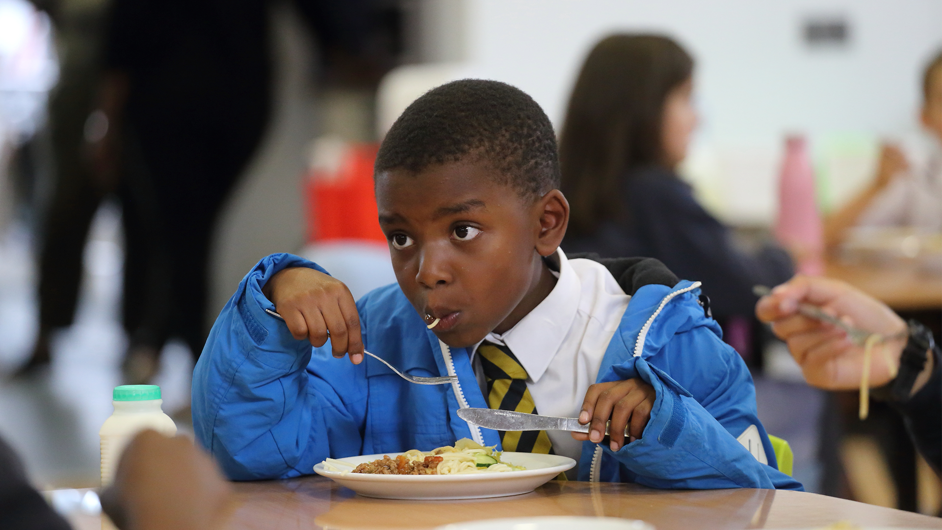a boy eating lunch at school